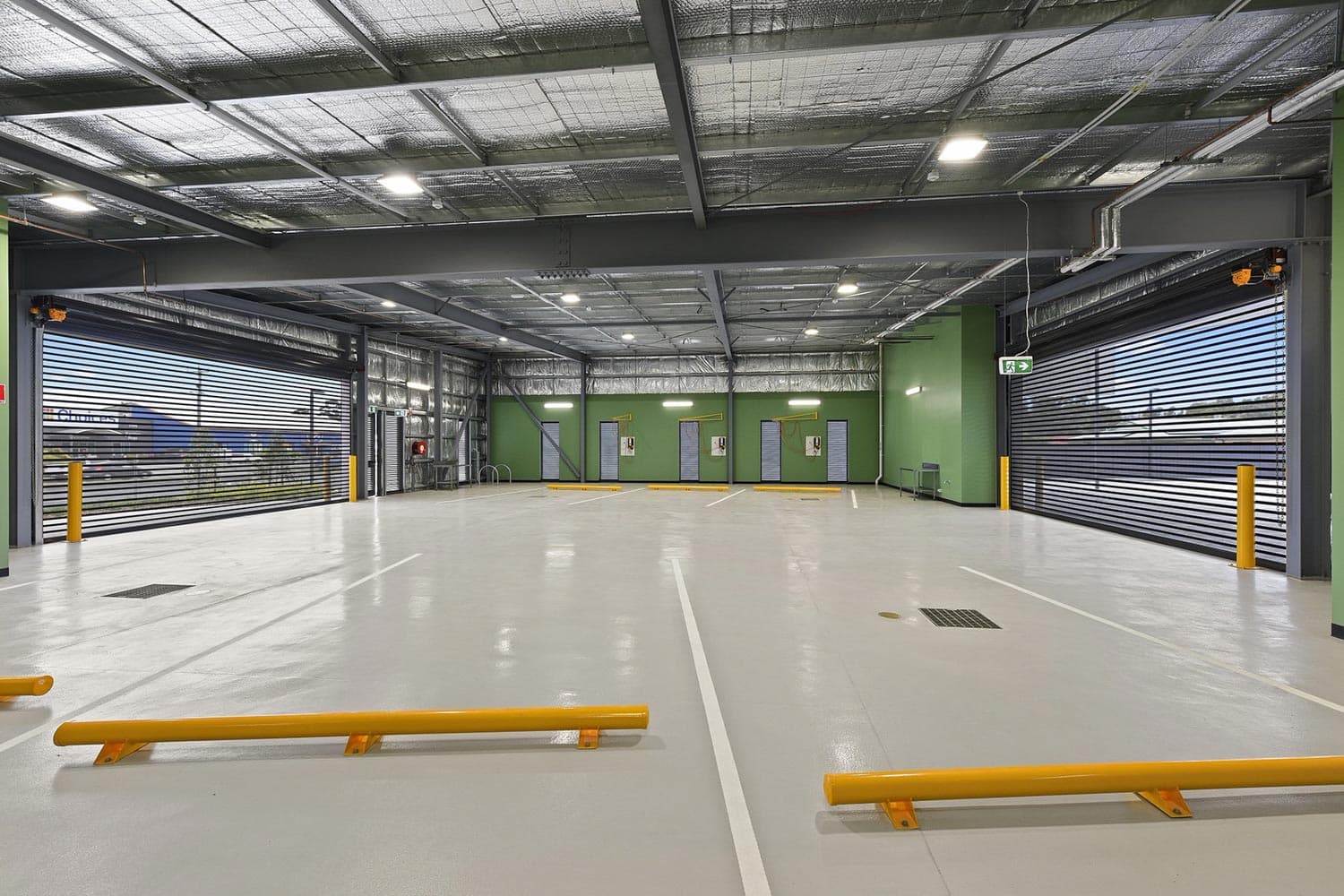 NSW Ambulance Station, vehicle bay interior, modular construction with roller doors and service fitout
