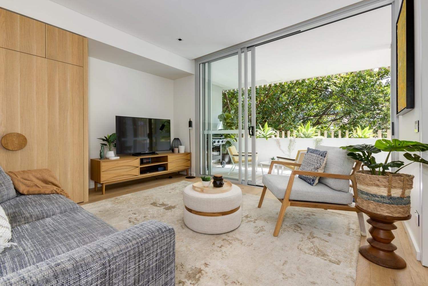 Calibre Cooper Street, apartment living room with timber joinery and private terrace