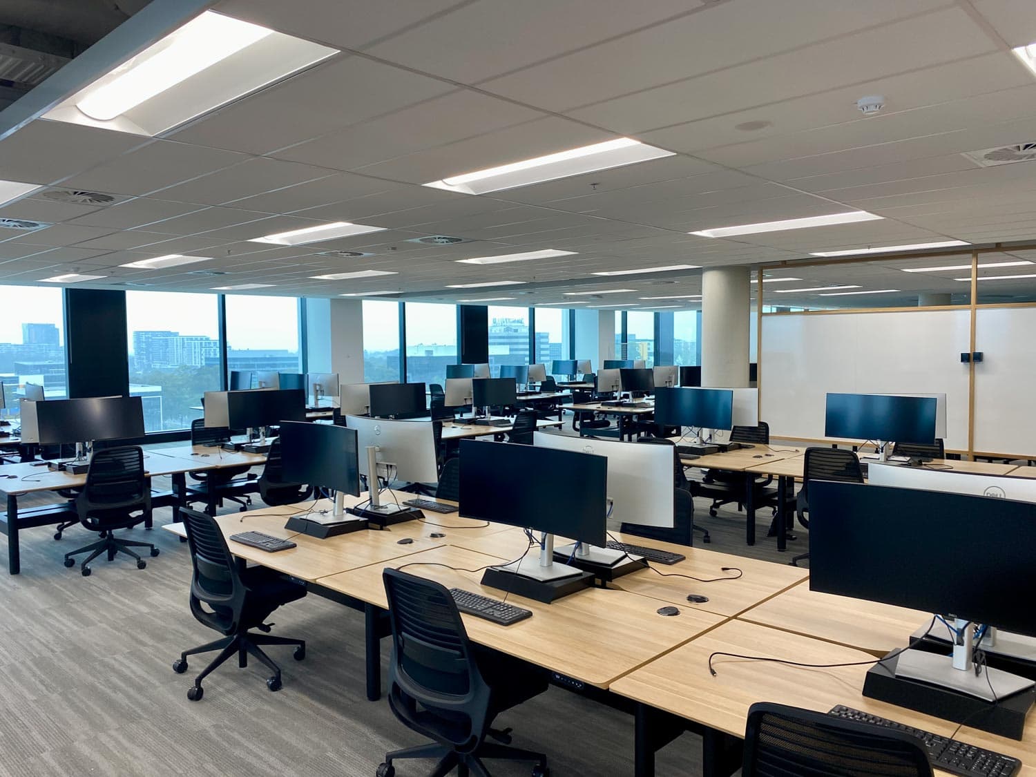 The Glasshouse, open plan workstation floor with views to Macquarie Park precinct