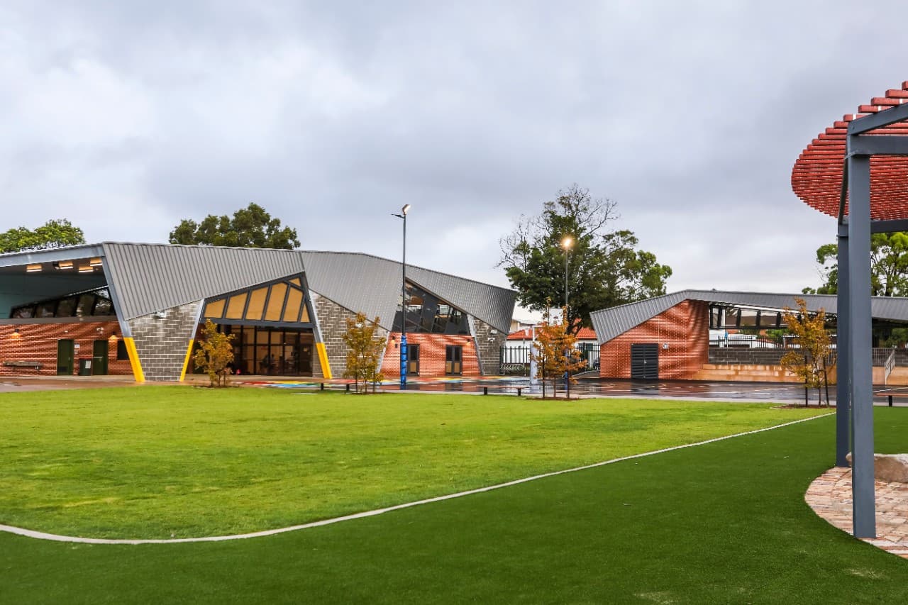 Kyeemagh Public School, nature-based playground and outdoor learning area with sandstone boulders and timber play equipment