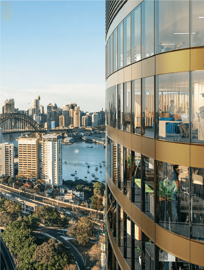 Render of the upper tower facade, curved gold-toned glass with recessed balconies framing views across Lavender Bay to the Harbour Bridge and Sydney CBD