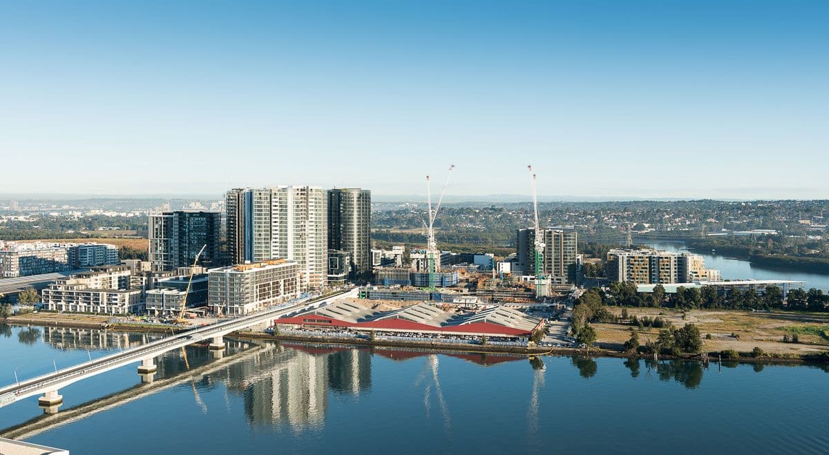 Aerial view of the Wentworth Point precinct showing the existing residential towers, construction activity, and waterfront site