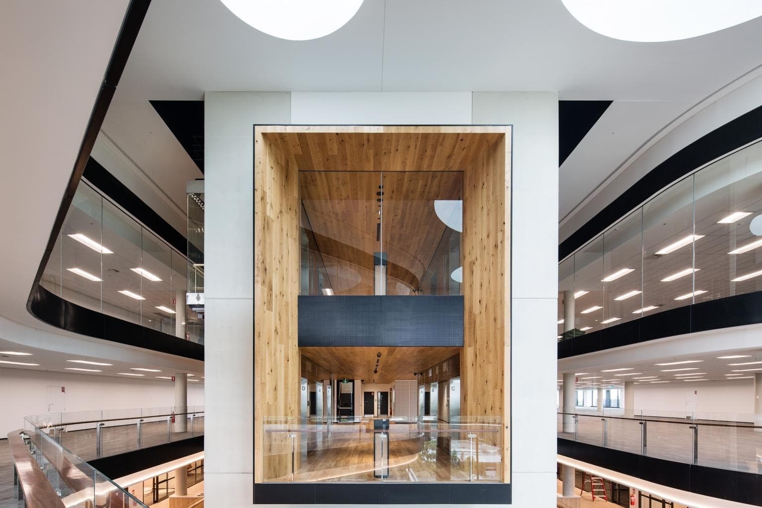 The Glasshouse, atrium detail with timber-lined meeting pod and open plan balconies