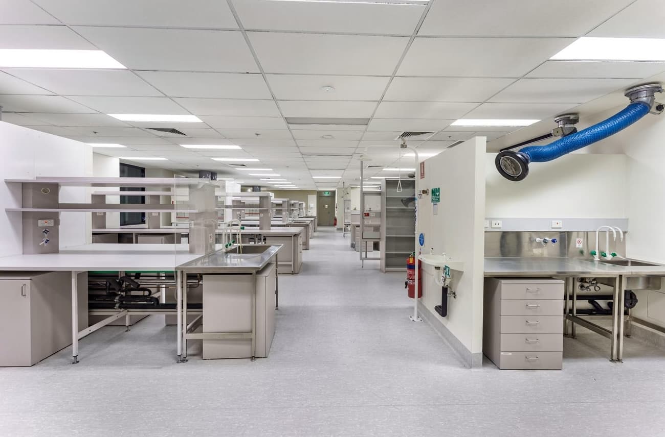 Laboratory interior, specialist fitout with fume cupboards, stainless steel benching, gas and purified water services